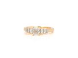une bague de fiançailles en or jaune sertie de trois diamants taille baguette