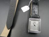 a watch that is sitting on a table next to a watch strap