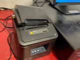 a computer and printer sitting on a desk next to each other