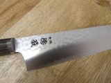 a large knife that is sitting on a wooden table