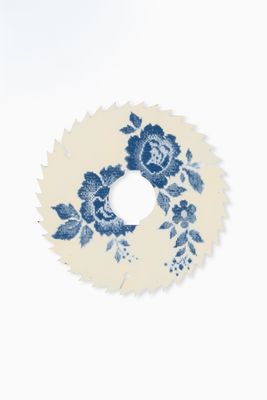 a blue and white floral wreath on a white wall