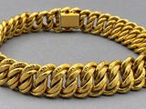 a gold chain bracelet with a clasp on a gray surface