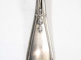 a spoon that is sitting on a white table