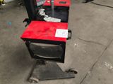 a red table with a black top and a black chair