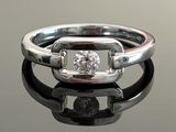 an image of a diamond ring on a reflective surface