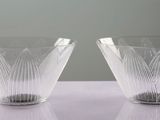 two clear glass vases sitting on top of a white table