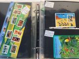 two binders with pictures of animals and birds on them