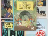 several children ' s books are lined up on a white surface