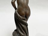 bronze statue of a woman with her back turned to the side