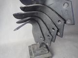 a metal sculpture of a bird that is on a stand