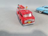 two toy cars sitting next to each other on a table