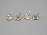 three pieces of silver metal on a white surface
