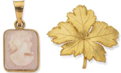 two gold pendants with a picture of a woman and a leaf