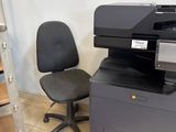 a photo of a printer and a chair in a room