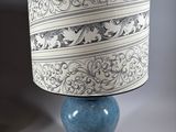 a lamp that is sitting on a table next to a wall
