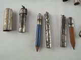 many different types of pens and pencils laid out on a table