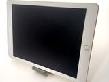 tablet computer sitting on top of a white table with a black screen