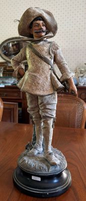 a statue of a man with a hat on a table