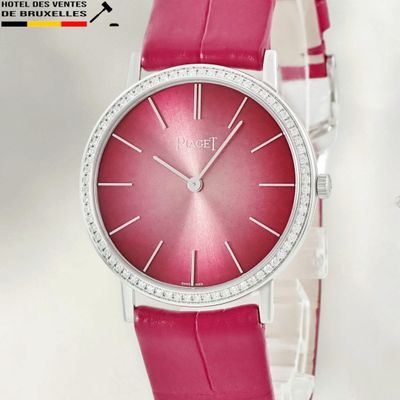 a pink watch with a diamond bezel on the face