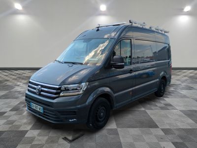 the grey van is parked in a large room with checkered flooring