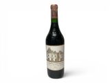 a bottle of wine sitting on top of a white table