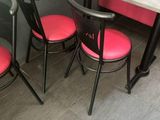 three chairs and a table in the corner of a restaurant