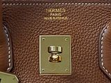 hermes ' s brown leather handbag with gold hardware on the handle