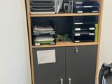 une bibliothèque sur laquelle sont posés tout un tas de fournitures de bureau