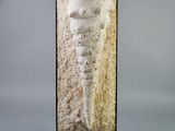 a sculpture of a woman standing on top of a wooden base