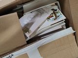 a box full of books and papers on the floor