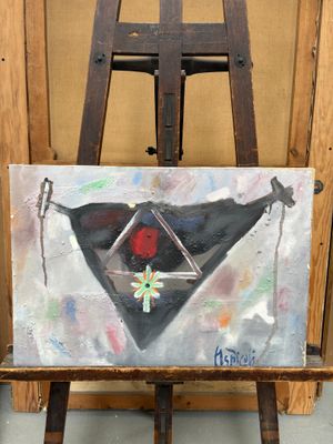 un tableau posé sur un chevalet, devant un chevalet en bois