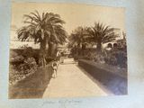an old photo of a man walking down a path