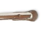 a small metal object on a white surface