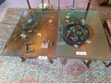 two glass tables with flowers on them on a rug