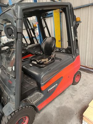 a forklift truck that is parked in a warehouse