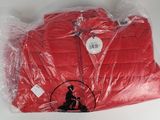 a red shirt wrapped in plastic on a white table