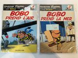 two books of cartoon comics are sitting on a table