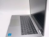 a silver laptop with a blue sticker on it