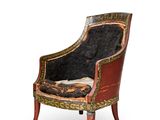 a chair that has a black and gold design on it