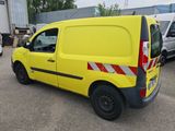 a yellow van that is parked in a parking lot