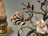 a chandelier with a flower and a candle holder on it