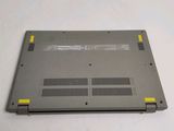 the bottom of a laptop with a yellow button on the side