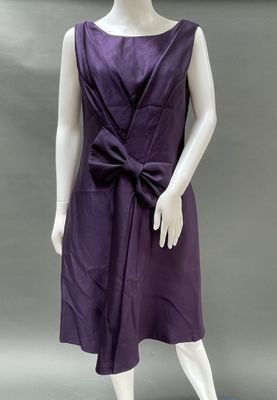 an image of a mannequin wearing a purple dress with a large bow