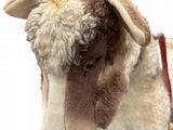 a stuffed animal that is standing on a white surface