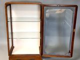 a small display case with glass shelves in it