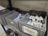 two bins filled with bottles of water in a storage area