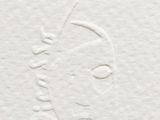 a close up of a piece of paper with a drawing of a woman ' s face on it