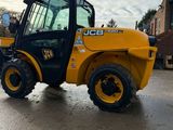 a picture of a yellow construction vehicle parked in a parking lot