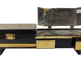 a black and gold chest with a mirror on it