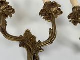 a pair of candles that are on the wall